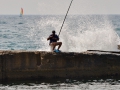 Not one to let a few waves ruin his fishing..