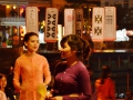 A game like bingo is being played. The woman with the microphone draws paddles, like what are hanging, and contestents simply need to have the right matching paddles.