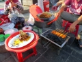 Street food! It's pork satay and then it gets rolled up into a fresh spring roll. So delicious!